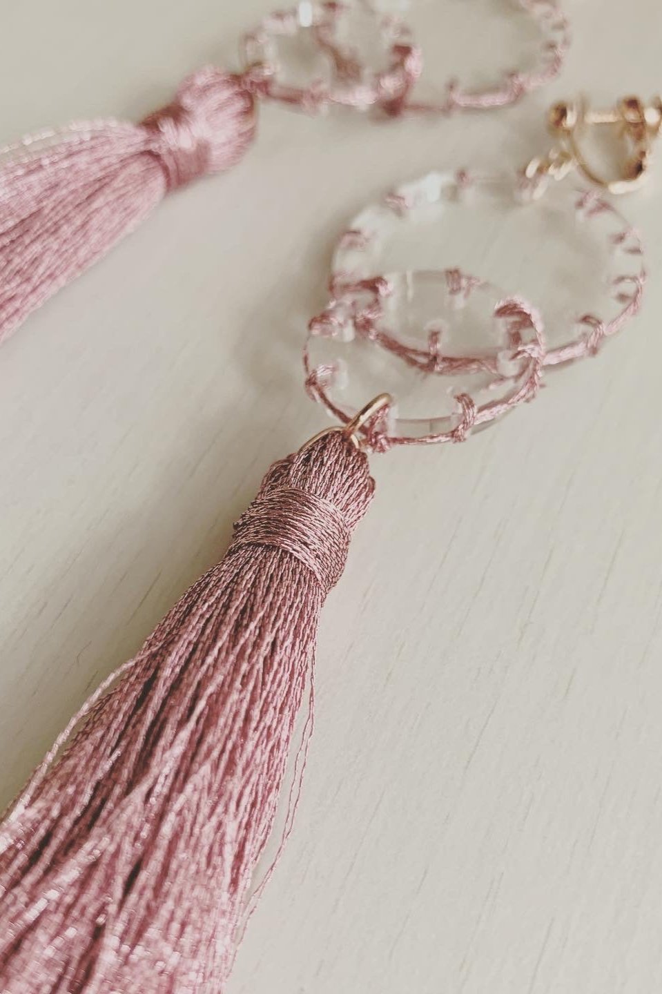 pink stitch layered tassel earrings