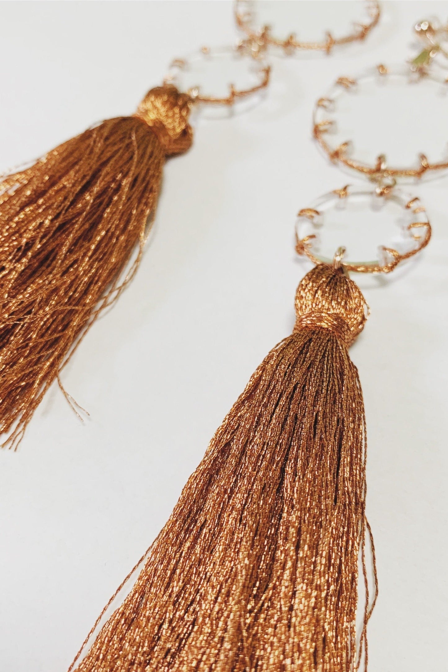 orange stitch tassel earrings