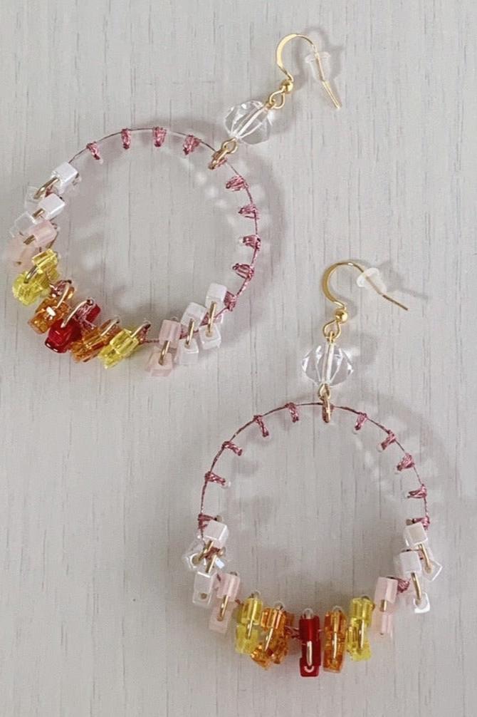 orange stitch tassel earrings