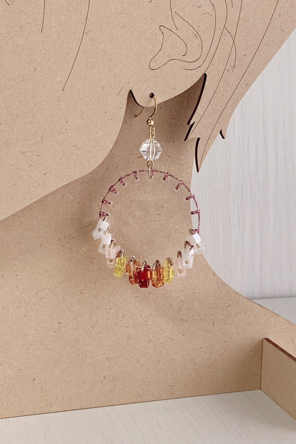 orange stitch tassel earrings
